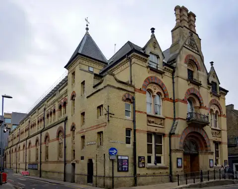 The yellow brick Victorian front of the Cambridge Corn Exchange on Wheeler Street