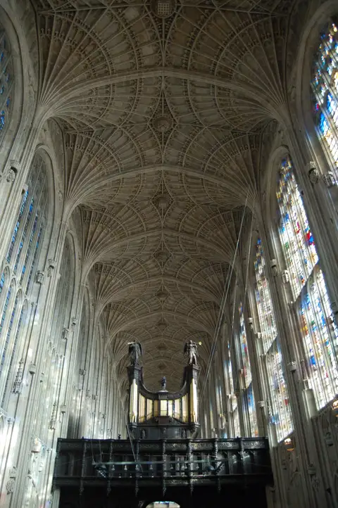 Looking up at the fan-vaulted roof of King's College Chapel above the carved organ case